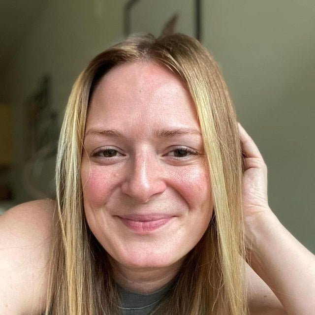 Reviewer photo: a smiling woman with long fair hair, one hand in her hair