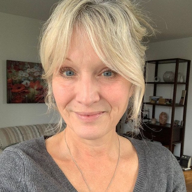 Reviewer photo: a woman with fair hair in a grey jumper, in a living room