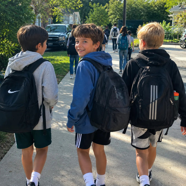 Three friends walking to school with their backpacks, rested and awake