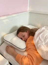 Girl asleep on her side on the Hushly Kids pillow