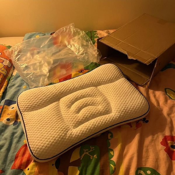 Pillow just out of its bag on a child's bed